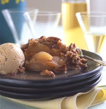 a black plate topped with ice cream and fruit