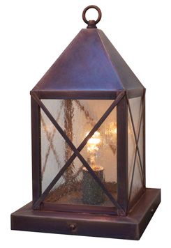 an old fashioned lantern with two lit candles in it's center and one light on the side