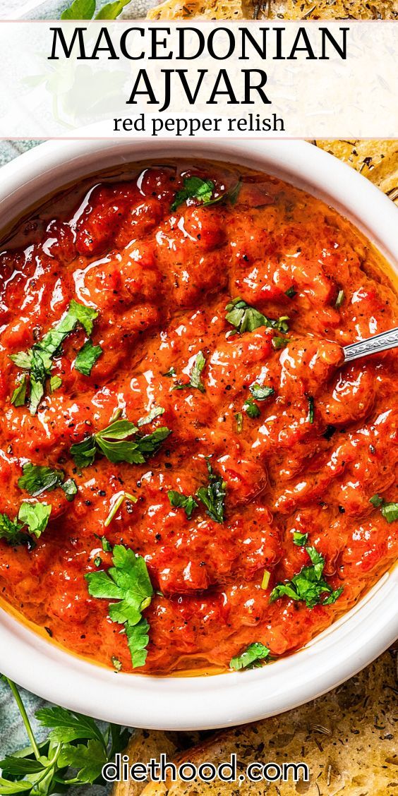 a white bowl filled with red pepper relish and garnished with cilantro