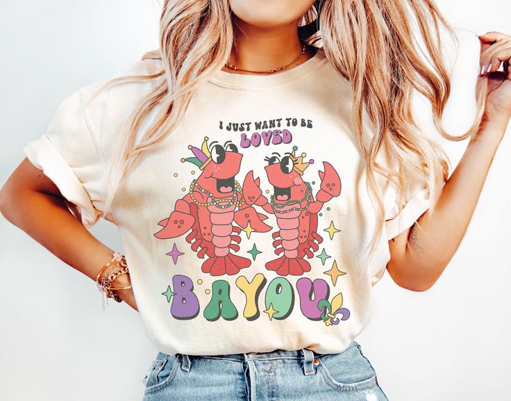 "Get ready to be OBSESSED with your new \"I Just Want to Be Loved Bayou\" crawfish graphic tee. It's the cutest and most trendy way to emit all those important Mardi Gras or Bayou engagement party vibes! DETAILS * Comfort Colors Garment-Dyed Heavyweight T-Shirt * 100% ring spun cotton * Design is printed using DTG technology which uses high-quality water-based inks that are printed directly into the fabric. This means that there may be a slightly faded/vintage look to the design depending on the Crawfish Shirt, Cowboy Santa, Mardi Gras Outfits, Queen Tee, Mardi Gras Shirt, Santa Shirt, Cowboy Christmas, Christmas Tshirt, Santa Shirts