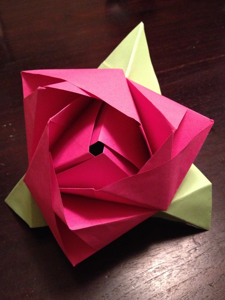 an origami flower on a wooden table