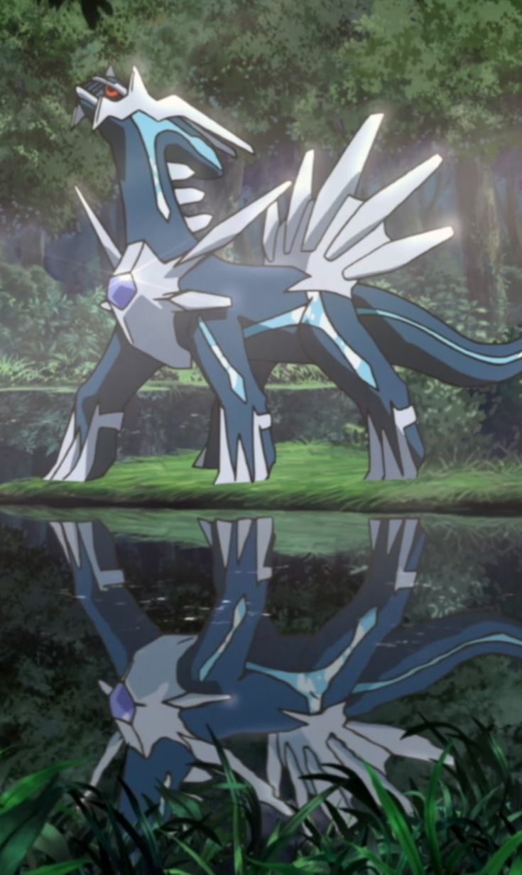 a blue and white dragon statue sitting in the grass next to a lake with trees behind it