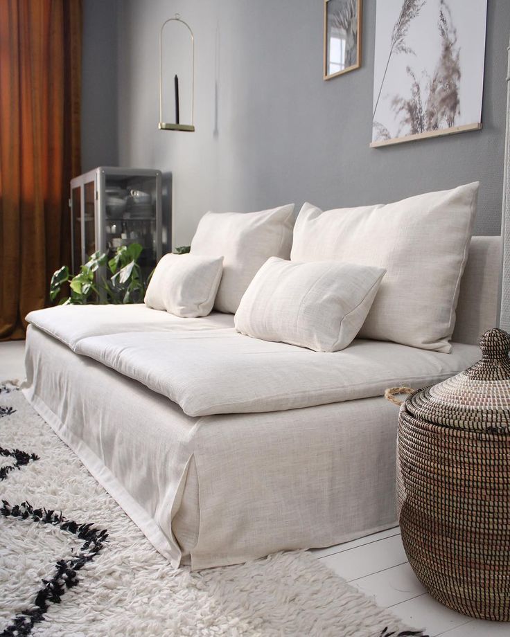 a white couch sitting on top of a rug in a living room