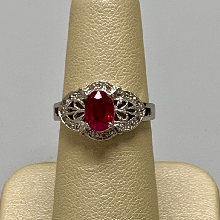 Stamped 14k White Gold Ladies Ring With A Filigree Design. In The Center Is An Oval Cut Ruby Weighing A 1.00 Carat. The Ring Also Contains 0.20 Carats Of Round Brilliant Cut Diamonds. The Rings Size Can Be Made To Your Finger Size. Michael Kors Ring, Prasiolite Ring, Ivory Ring, David Yurman Ring, Ruby And Diamond Ring, Ladies Ring, 18k Gold Ring, Filigree Design, Filigree Ring