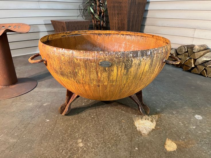 a large wooden bowl sitting on top of a cement floor