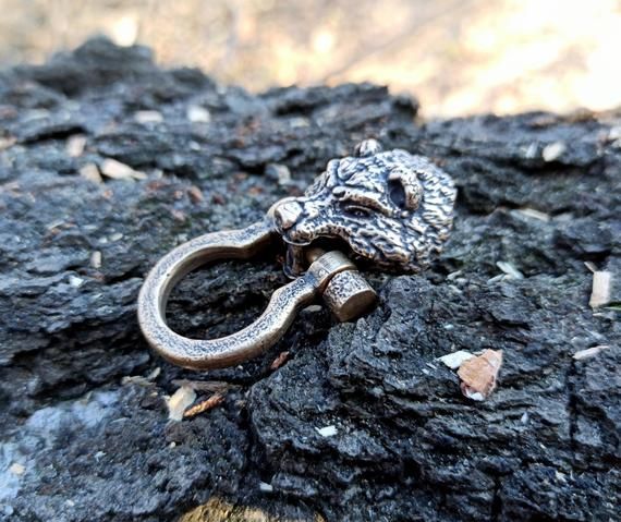 an old pair of scissors is sitting on some rocks