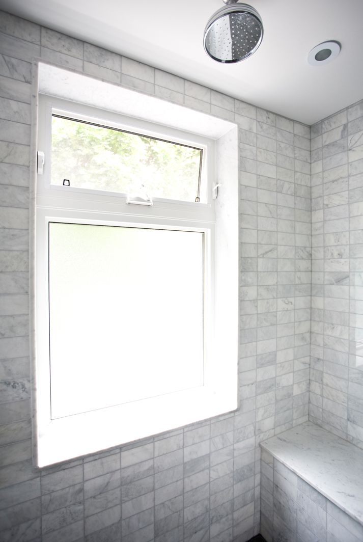 an image of a bathroom with windows by a bathtub on the left and right side