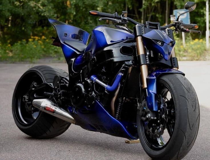 a blue motorcycle is parked on the street