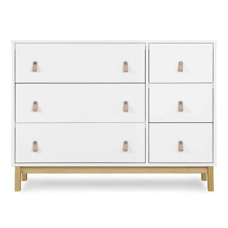 a white dresser with wooden handles and drawers