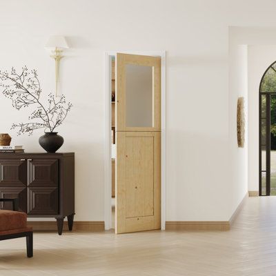 a living room with an open door and wooden furniture