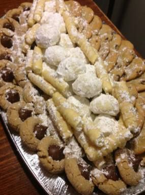 a platter filled with cookies and marshmallows on top of a wooden table