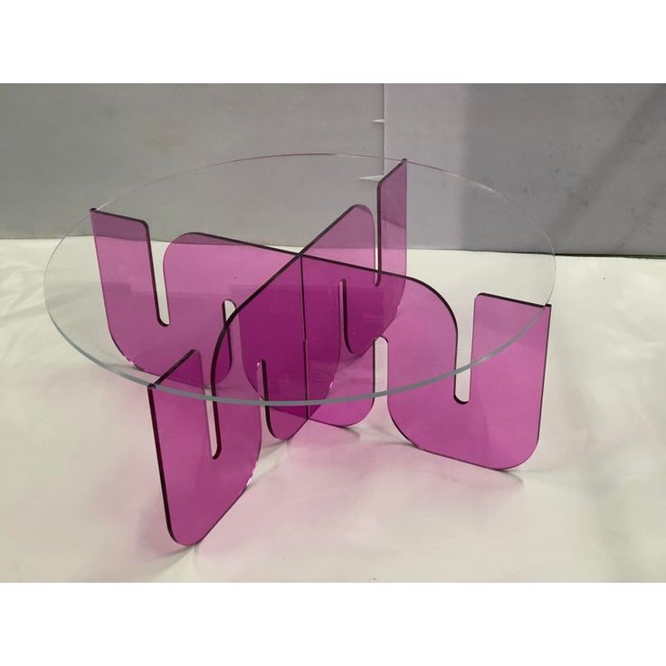 a pink glass table with the word joy on it's bottom and letters below