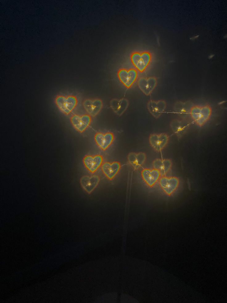 a cross made out of hearts in the dark