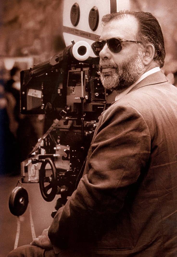 a man sitting in front of a movie camera