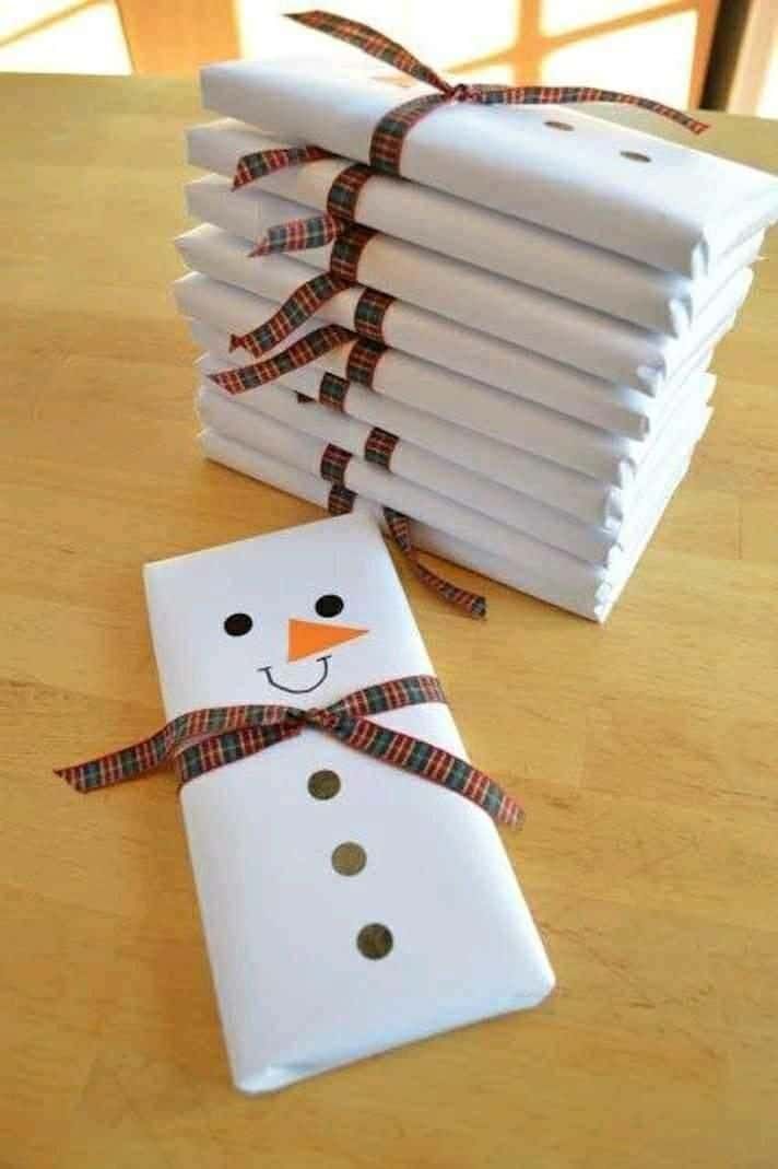 a snowman made out of napkins sitting on top of a table next to a stack