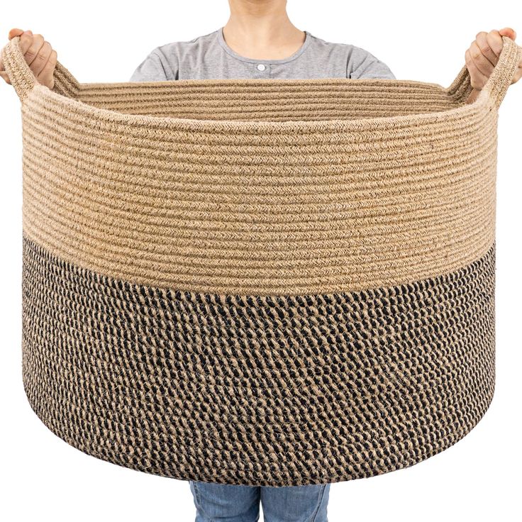 a person holding a large woven basket in front of their face and the bottom half of it