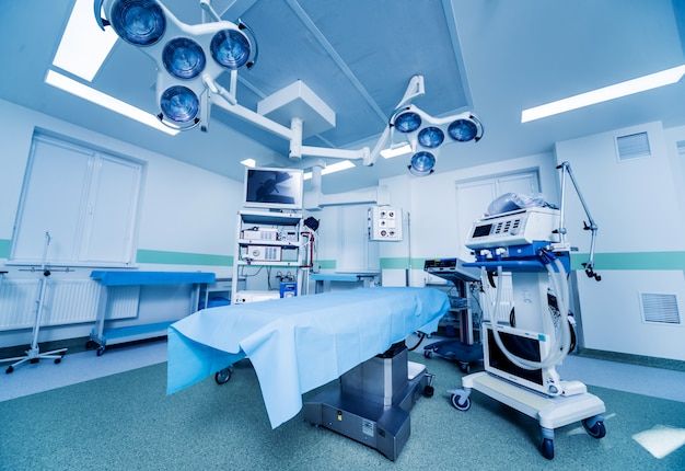 an operating room with lights and medical equipment