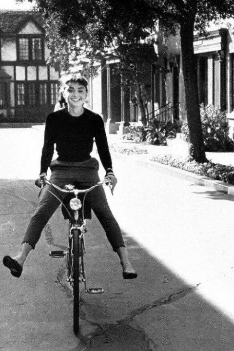 a woman is sitting on top of a bicycle