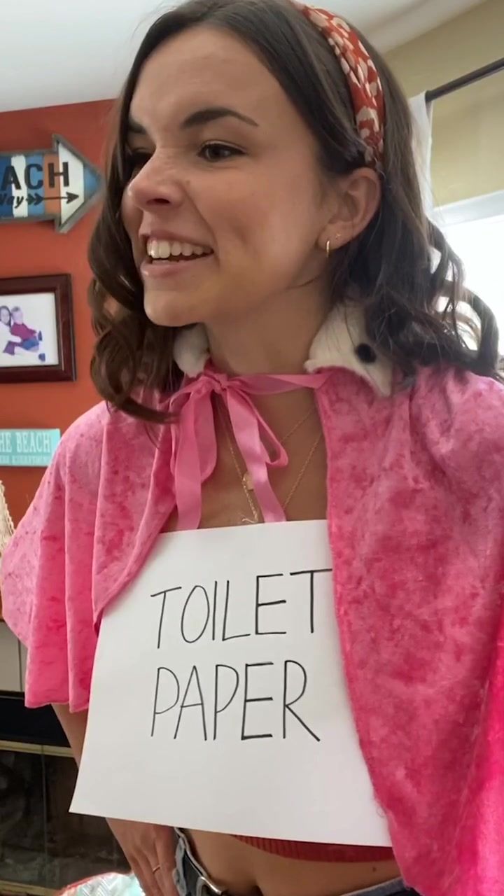 a woman holding a sign that says toilet paper