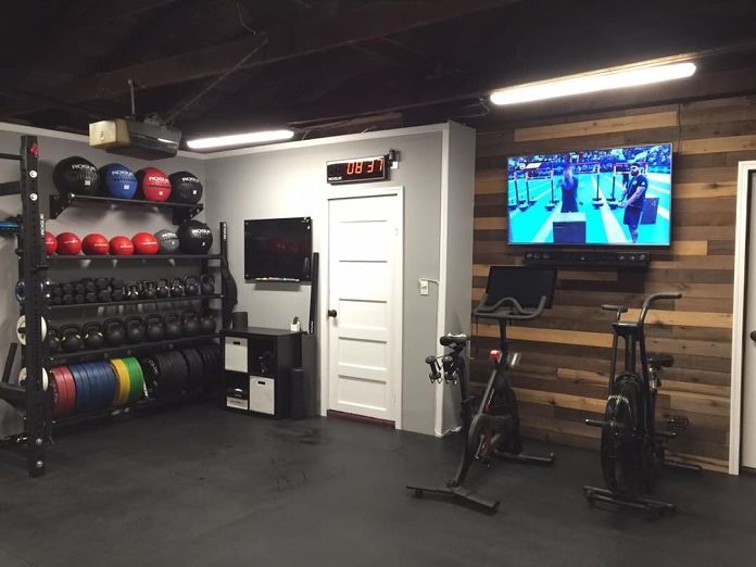 a gym with exercise equipment and a flat screen tv