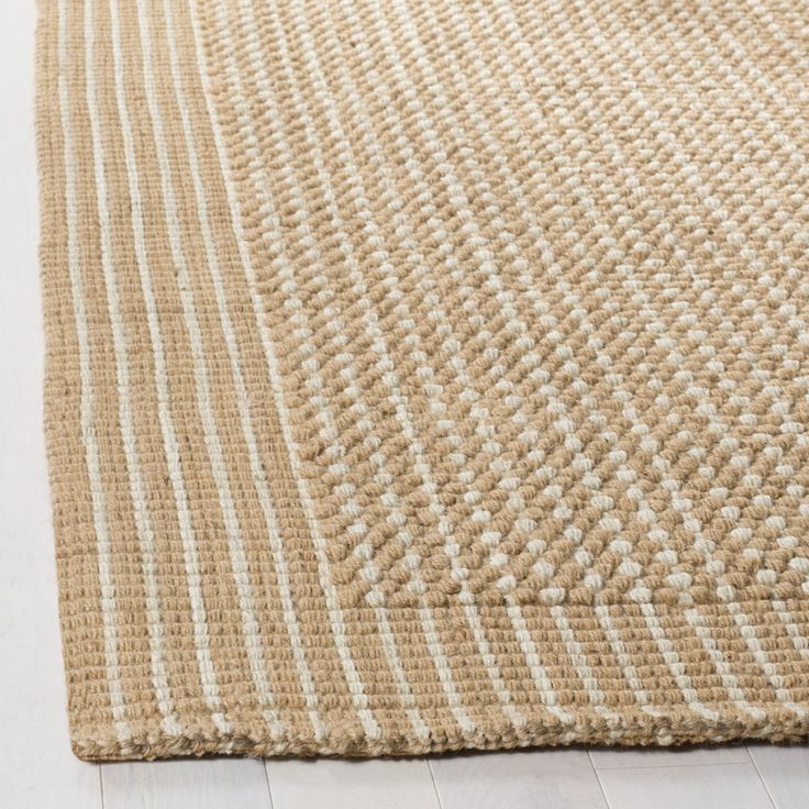 a beige and white rug on the floor