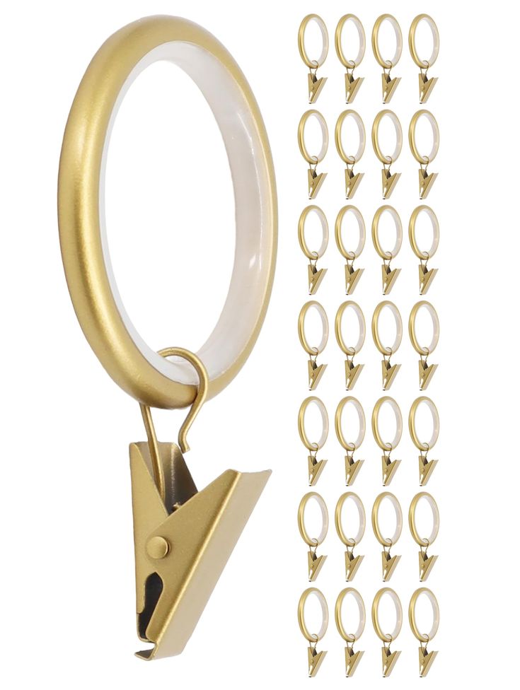 a pair of scissors and hooks are next to each other on a white background with gold rings