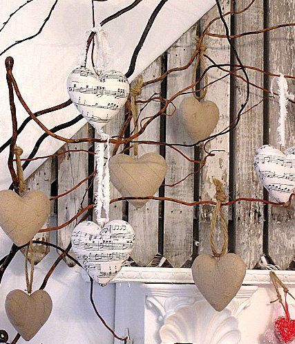 several hearts are hanging from a tree branch