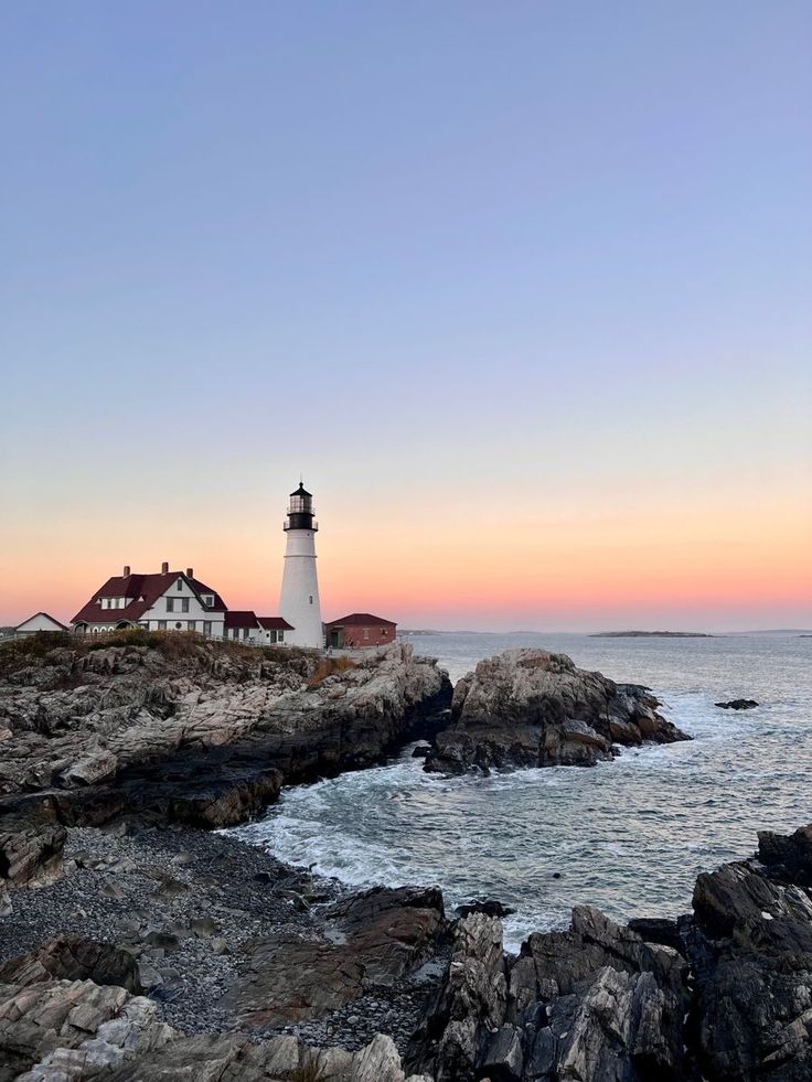 a light house sitting on top of a rocky shore