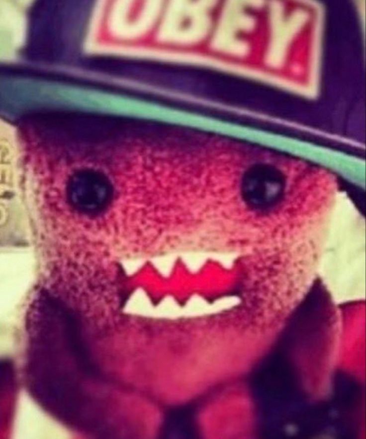 a teddy bear wearing a hat with teeth on it's face and mouth is shown