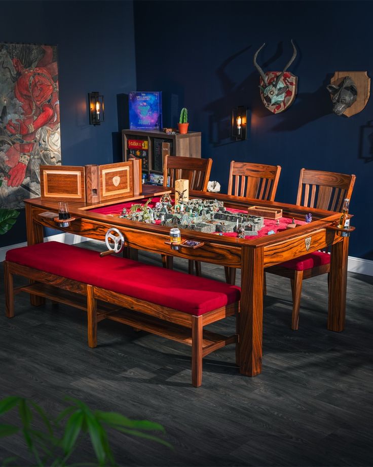 a dining room table and bench with red cushions