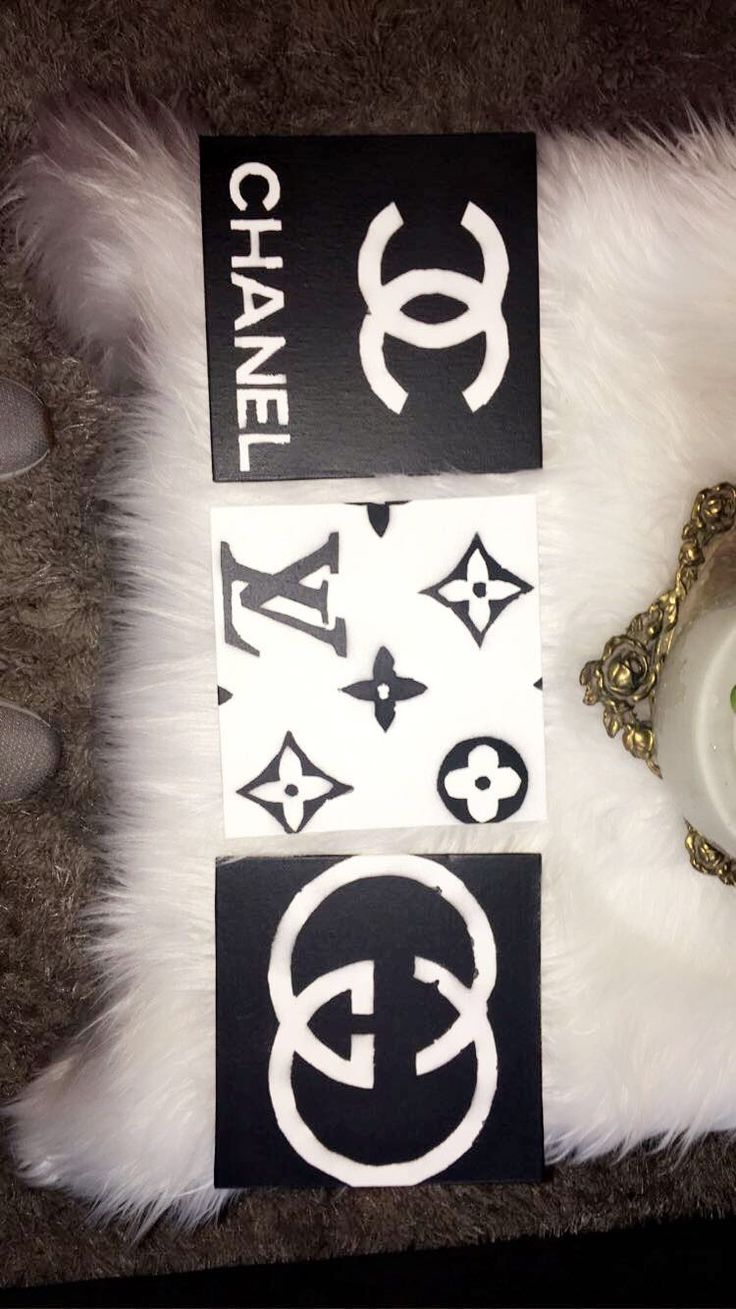 some stickers are laying on top of a white fur covered pillow with a gold ring