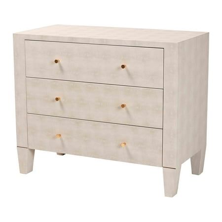 a white dresser with three drawers and gold knobs on the bottom, against a white background