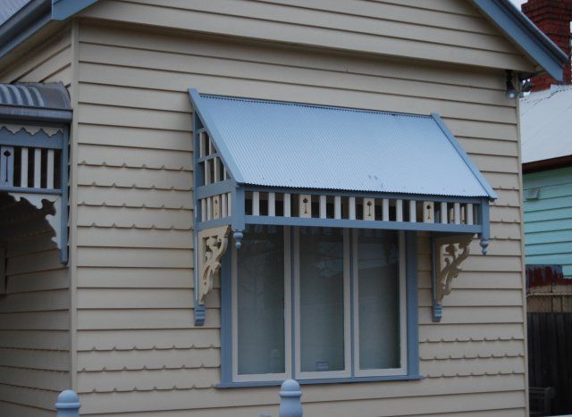 an old house with a blue awning on the front