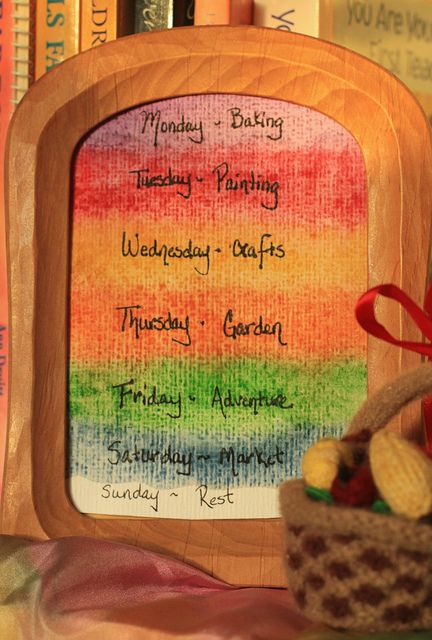 a wooden frame holding a rainbow colored menu