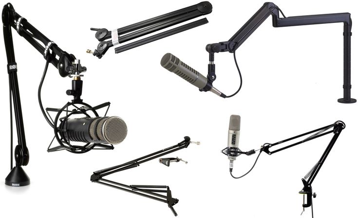 multiple microphones and stands on a white background, including one with a mic in the foreground