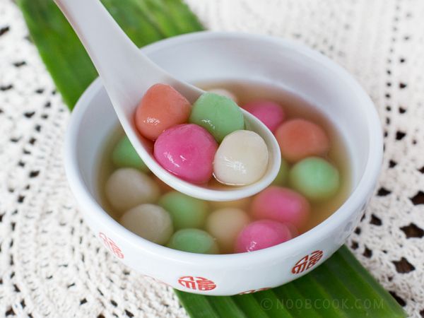 a bowl filled with candy on top of a green leaf