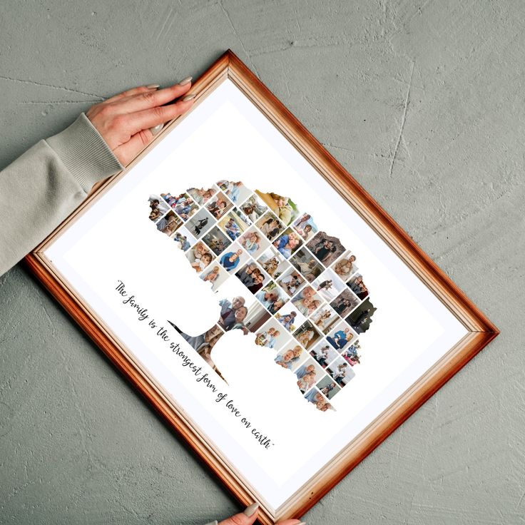 a person holding up a framed photo with many pictures on it