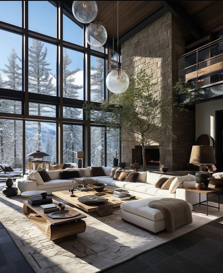 a living room filled with furniture and large windows