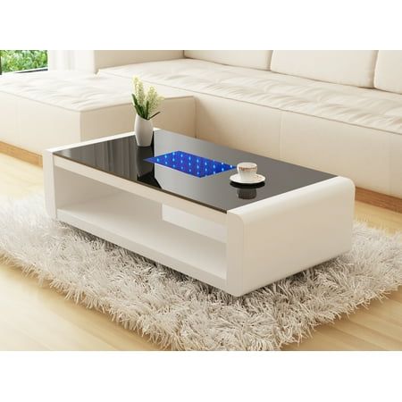 a coffee table with a blue light on it in the middle of a living room