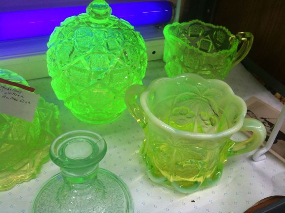 green glass dishes and pitchers on a table