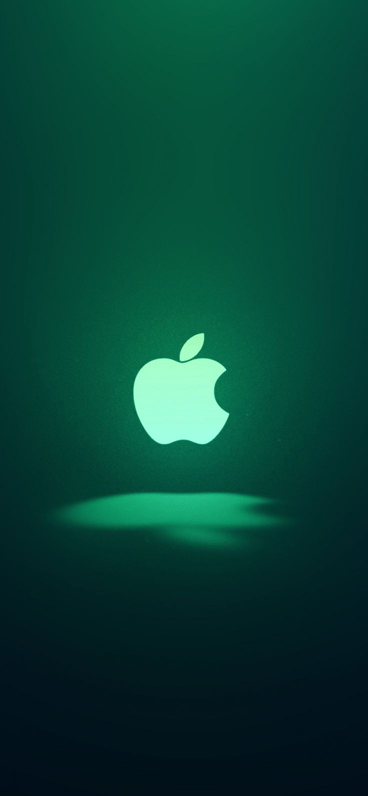 an apple logo is shown on a dark green background with light coming from the top