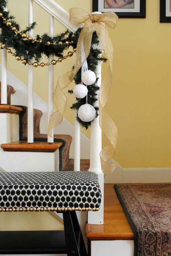 the stairs are decorated for christmas with garland and balls