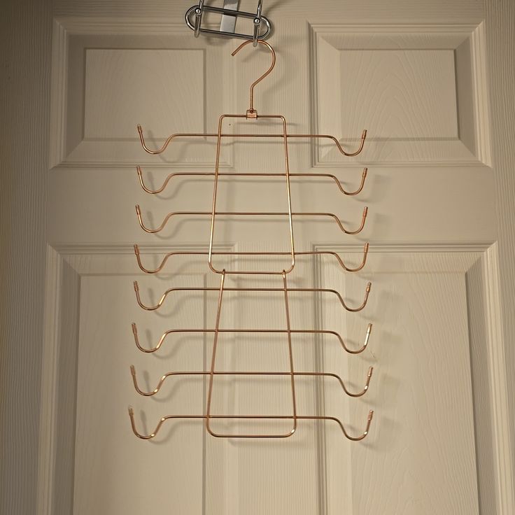 a metal rack hanging from the side of a door