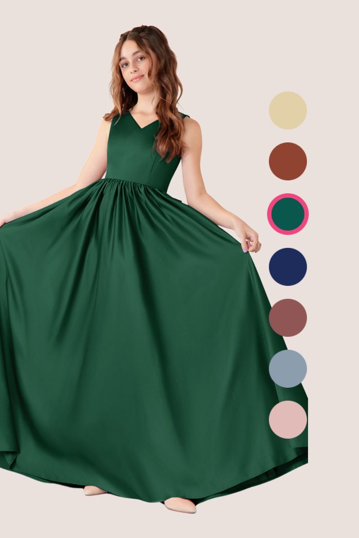 a woman in a long green dress standing next to color swatches and the colors