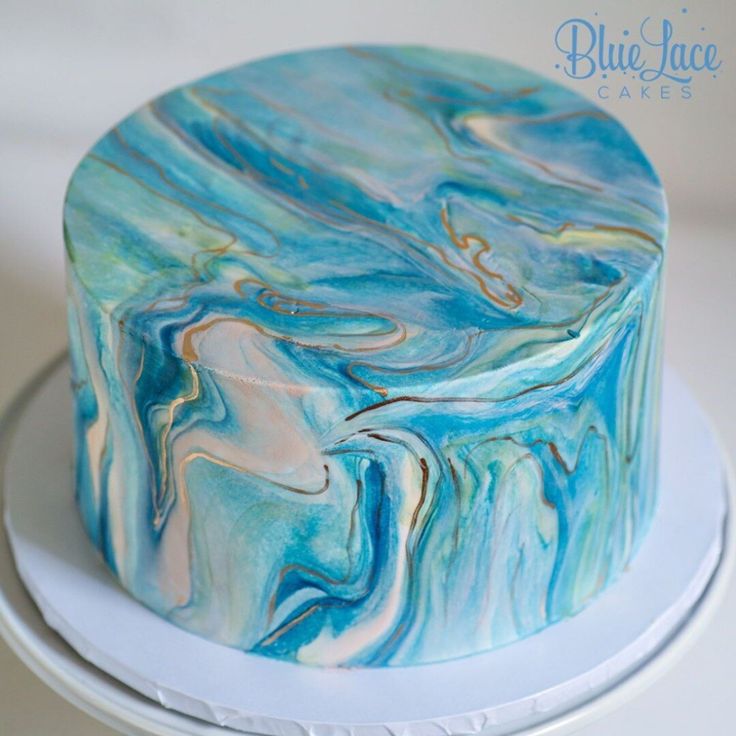 a blue and white marbled cake sitting on top of a plate