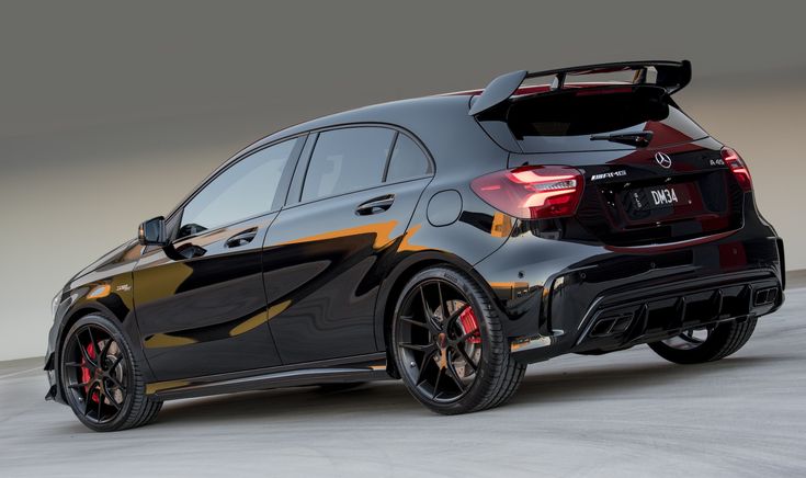 the rear end of a black and orange car