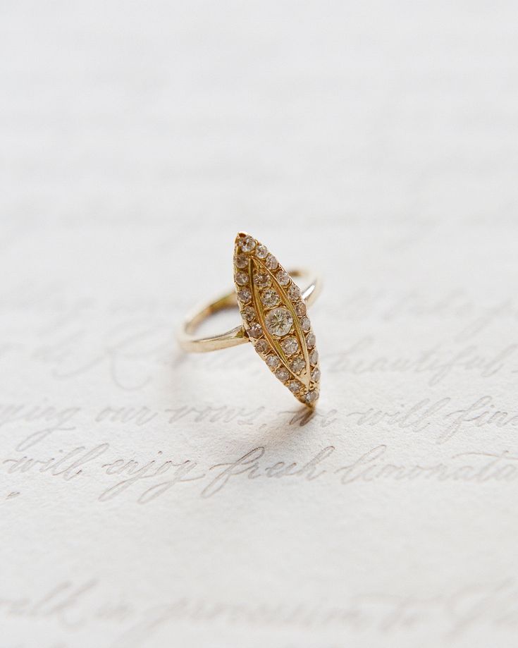 a gold ring sitting on top of a piece of paper