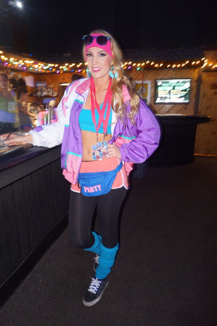 a woman dressed in costume standing next to a bar