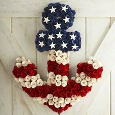 an anchor made out of red, white and blue flowers