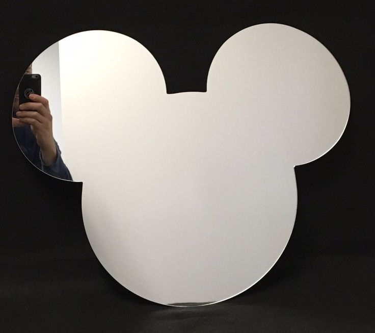 a person taking a selfie in front of a mickey mouse mirror